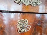 a close up of a wooden chest of drawers
