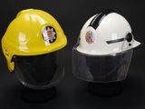 yellow and white hard hats with face shields on a black background