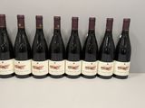 six bouteilles de vin sont alignées sur une table