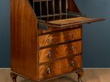 an old wooden desk with a drawer on top of it