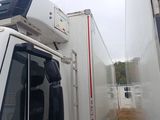 a white truck that is parked next to a building