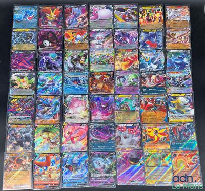 a pile of pokemon cards sitting on top of a table
