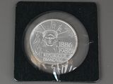 a silver coin with the statue of liberty on it