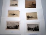several old black and white pictures of ships on display in a museum