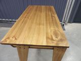 a wooden table that is sitting in the middle of a room