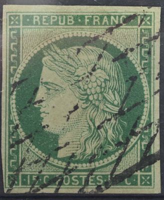 un timbre vert sur lequel figure la tête d'une femme