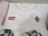 a white t - shirt with a lion on it next to a pair of shorts
