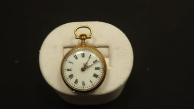une montre de poche en or avec des chiffres romains