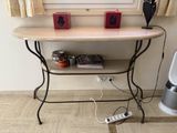 a table with a shelf and a remote control on it