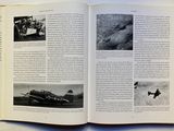 an open book with pictures of airplanes flying in the sky
