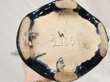 a close up of a person ' s hand holding a plate with numbers on it