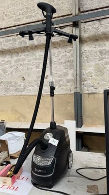 a vacuum that is sitting on a table in front of a tv