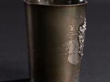 a silver cup that has a picture of a woman on it