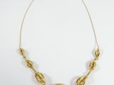 an image of a gold necklace on a white background