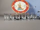 a lot of glasses and a plate with a picture on it