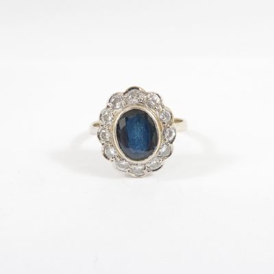 a blue sapphire and diamond cluster ring