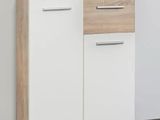 a close up of a white cabinet with a plant on top of it