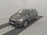 the grey car is parked in the garage on the checkered floor