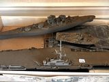 a cardboard box with a model of a battleship in it