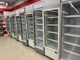 a row of empty refrigerators in a store
