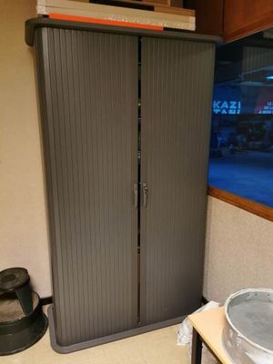 a large cabinet with a sink in the corner of a room