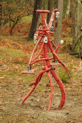 a red fire hydrant in the middle of the woods