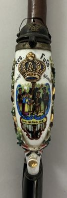 a close up of a cane with a picture of a crown on it