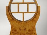 a wooden sculpture with a circular design on top of it
