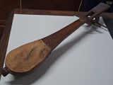 a wooden instrument that is on display on a table