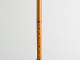 a wooden flute on a white background