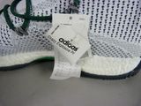 adidas ultraboost running shoes with a price tag on the sole
