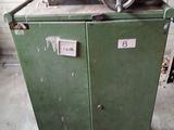 a machine that is sitting on top of a green cabinet