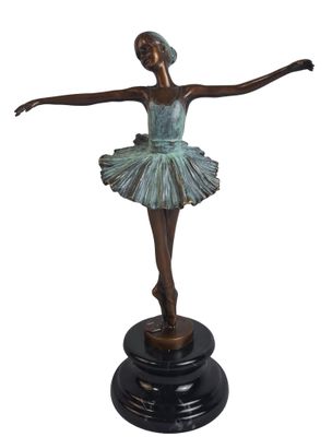 bronze statue of a woman in a tutu on a pedestal