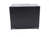 a black box with a lid sitting on a white surface