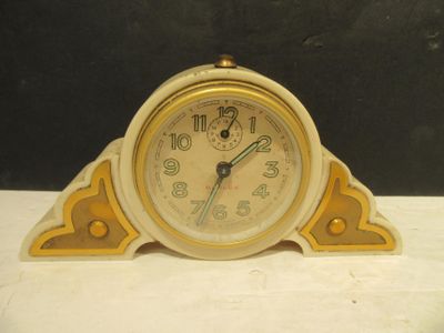 yellow and white clock sitting on top of a white table