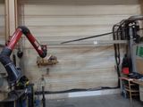a robot that is attached to a wall in a garage