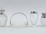 three glass salt and pepper shakers and a glass basket