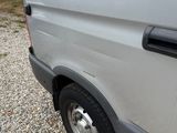 a white van that is parked in the gravel