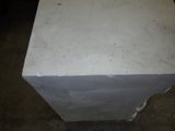 concrete block sitting on top of a floor in a room