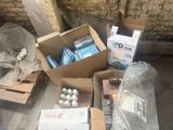 many boxes of golf balls in a pile on the ground
