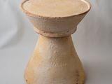 a small wooden stool sitting on a white surface