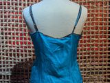 blue satin camiso top with beaded straps on a mannequin