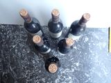 several bottles of wine are lined up on a counter top