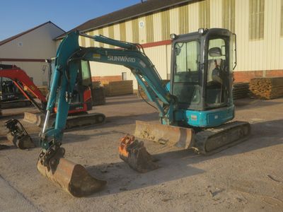 a picture of a small excavator parked in a lot