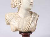 a white marble bust of a woman on a wooden stand
