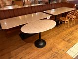 two tables and two chairs in the corner of a restaurant