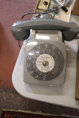 a telephone that is sitting on a table next to a box