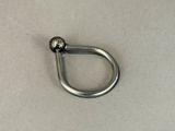a metal hook with a ball on it on a table