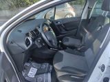 the interior of a car with the door open and the driver ' s seat down