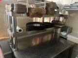stainless steel counter top in a commercial kitchen with pots and pans on it